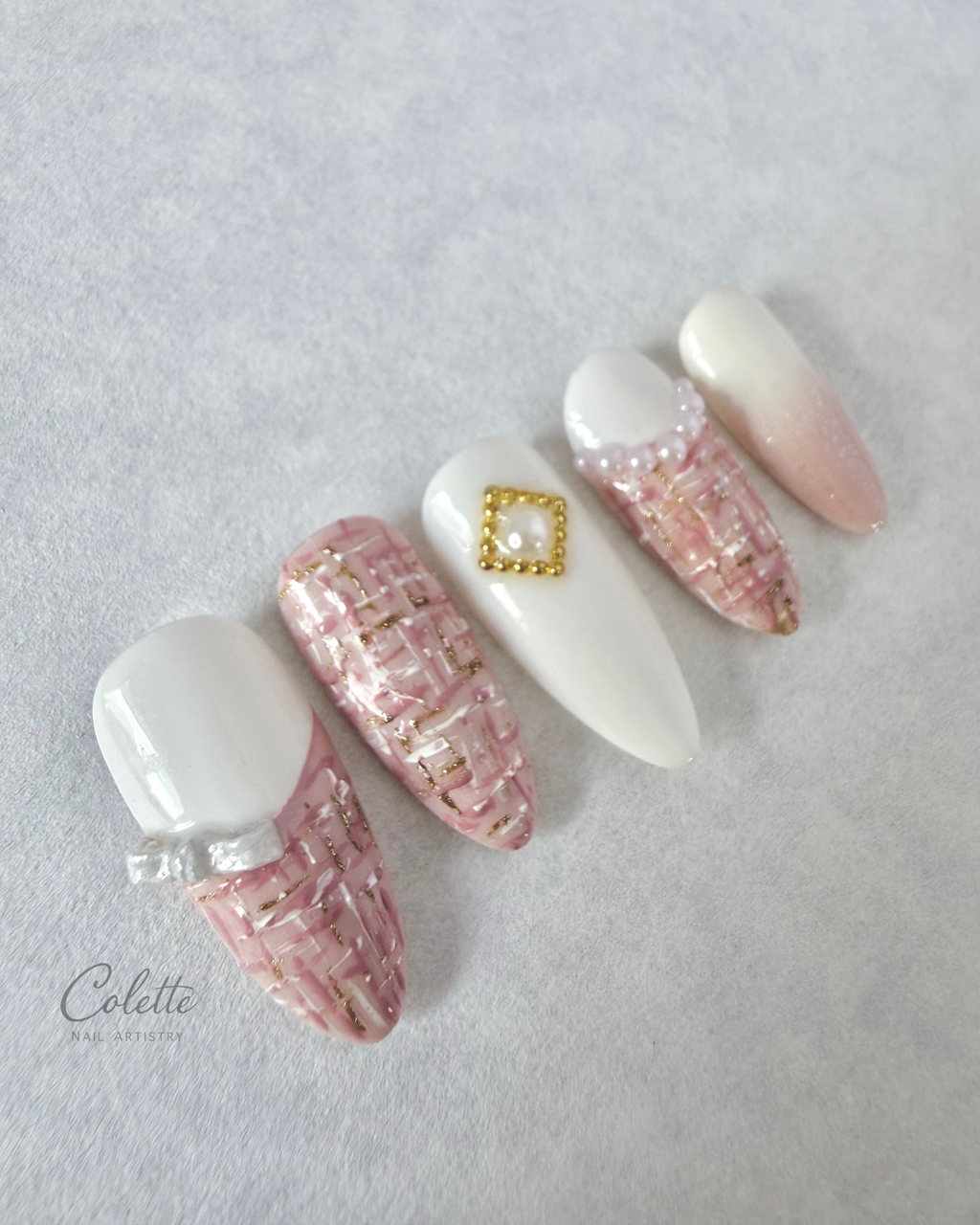Tweed Glow press-on nails in pink and white with textured tweed detailing, 3D bow and pearl accents.